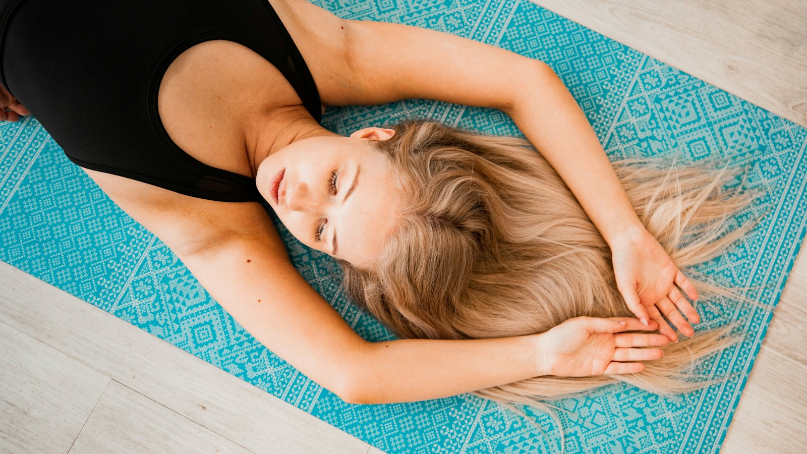 A person resting on a mat, letting the body settle into a gentle tremor